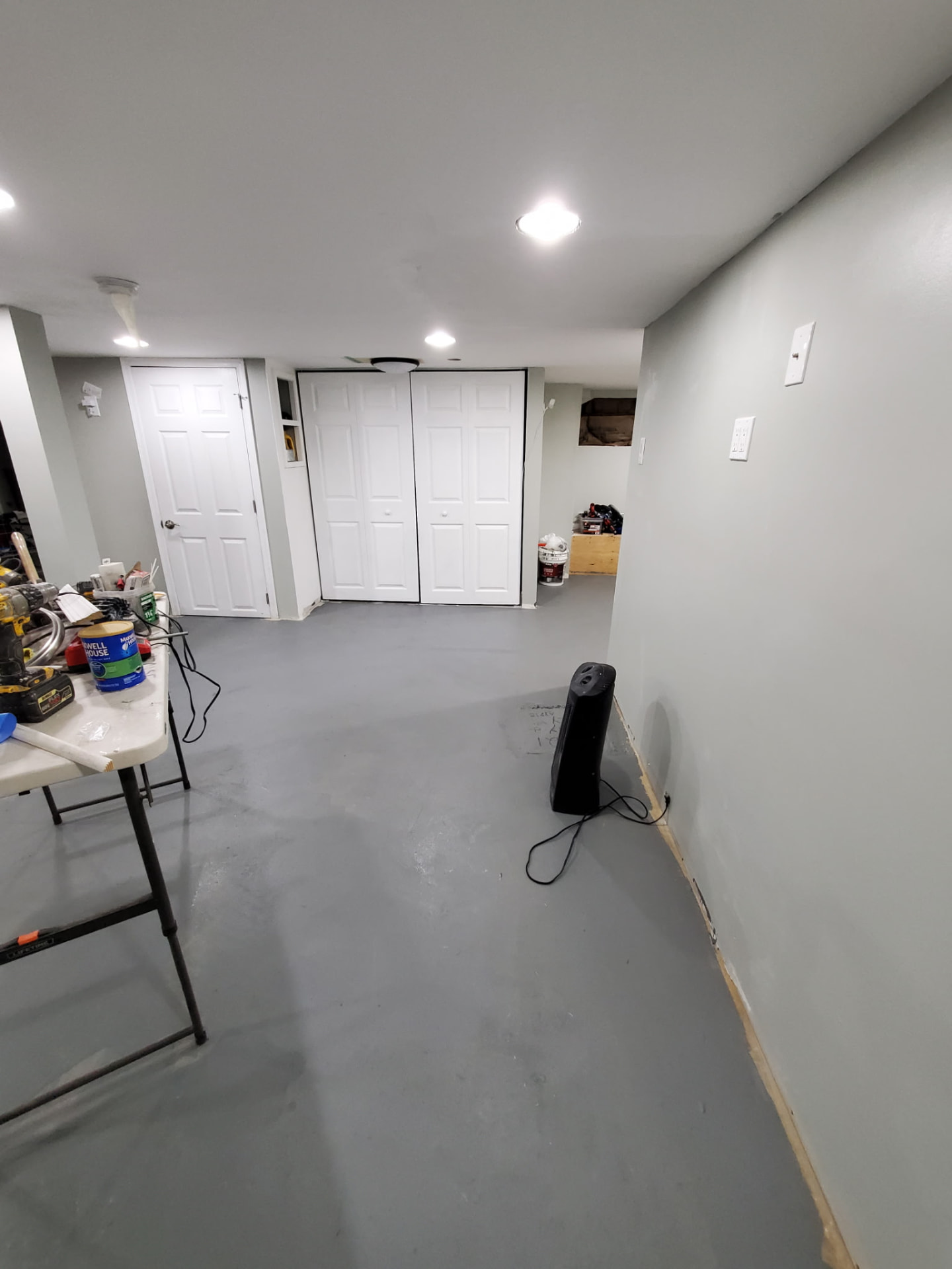 Basement with freshly coated gray floor and painted walls