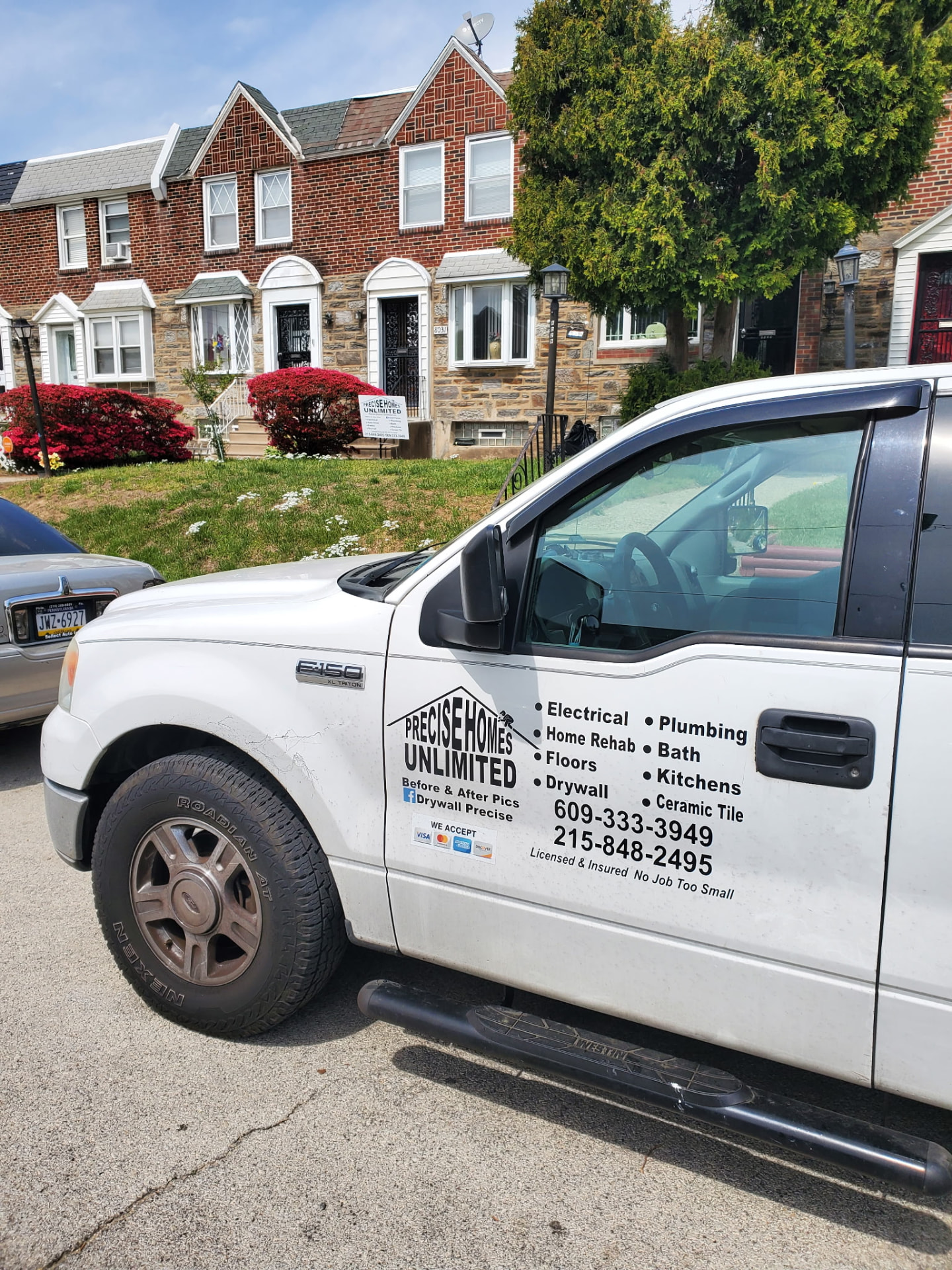 Precise Homes Unlimited work truck parked on a Philadelphia rowhome street