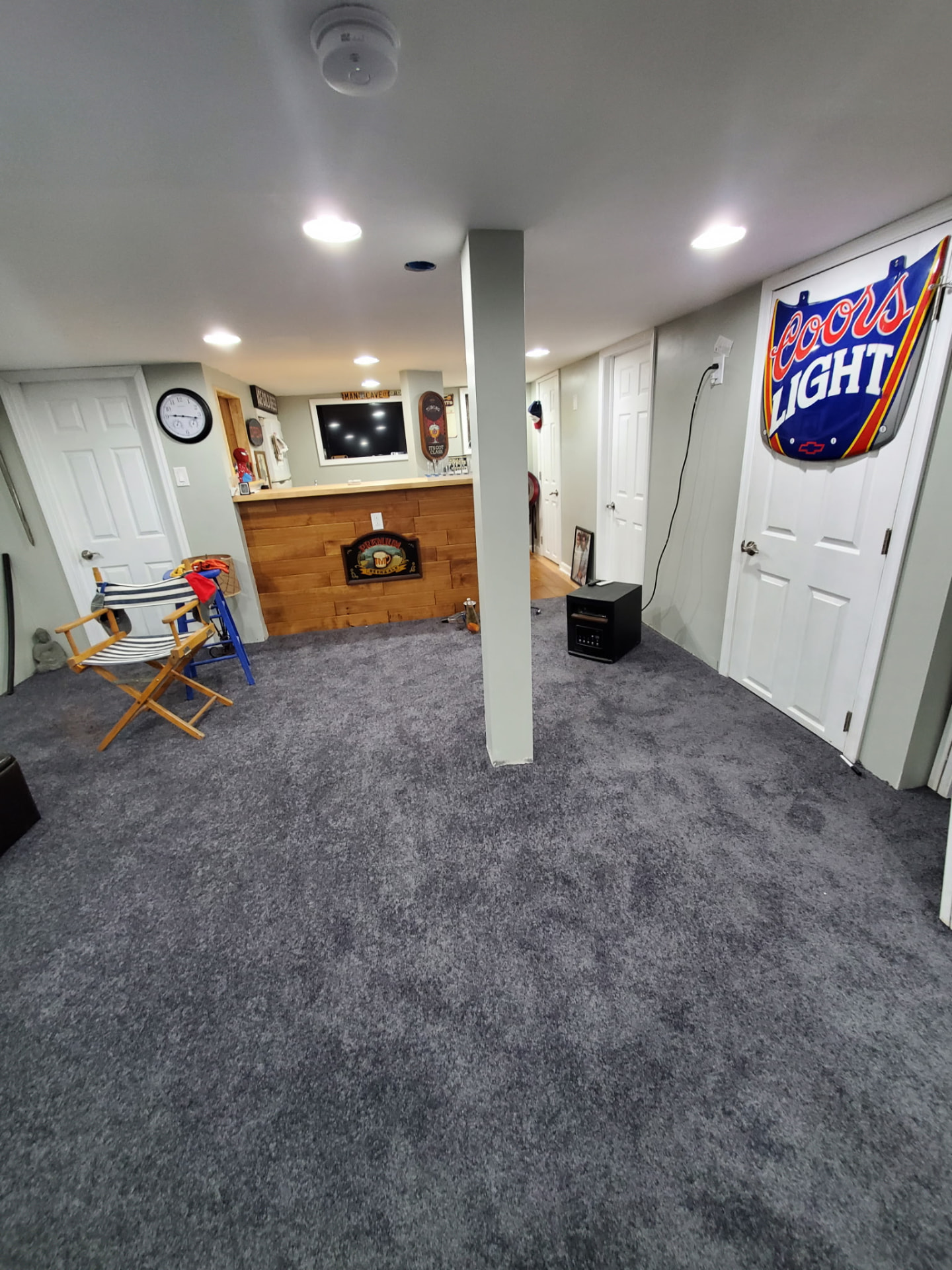 Finished basement with carpet, recessed lights and painted walls
